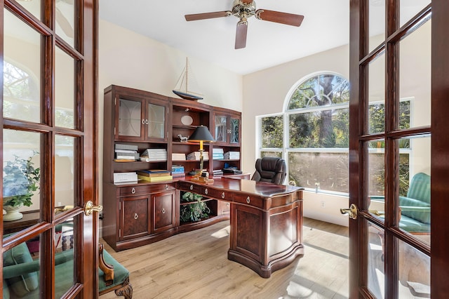 home office featuring french doors, ceiling fan, lofted ceiling, and light hardwood / wood-style floors