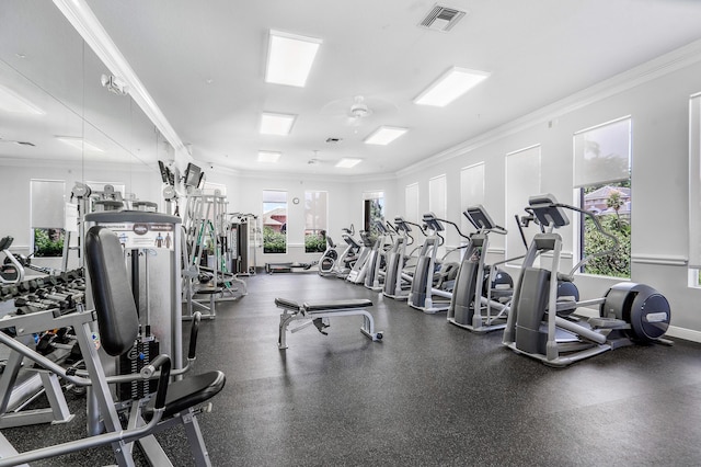 workout area featuring crown molding