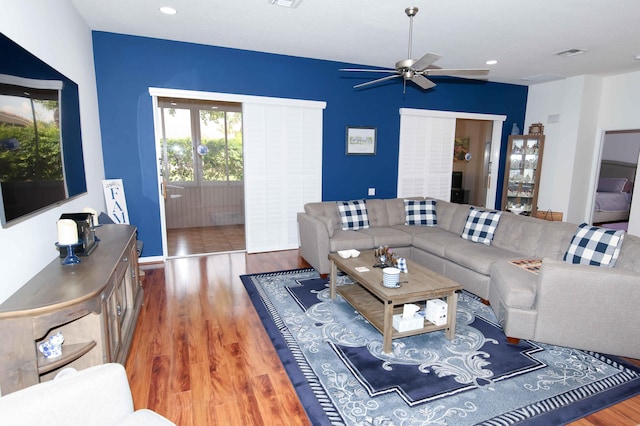 living room with hardwood / wood-style flooring and ceiling fan