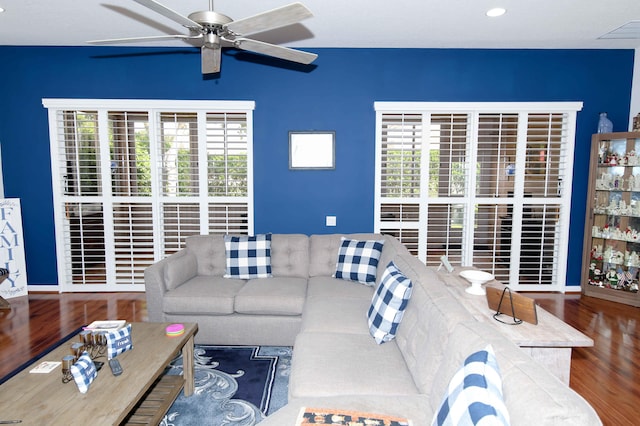 living room with ceiling fan, a healthy amount of sunlight, and dark hardwood / wood-style flooring