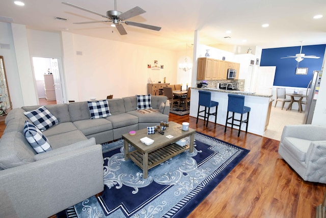 living room featuring hardwood / wood-style floors and ceiling fan