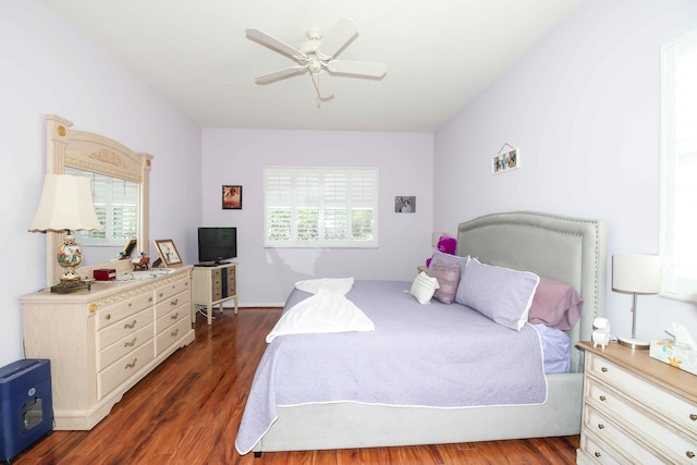 bedroom with ceiling fan and dark hardwood / wood-style floors