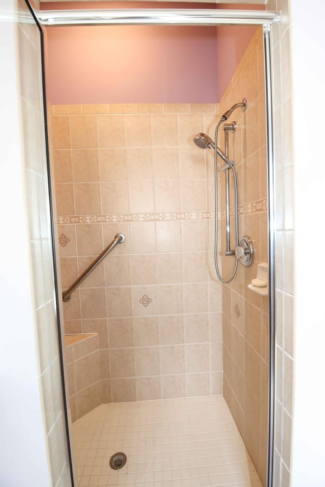 bathroom featuring a shower with door