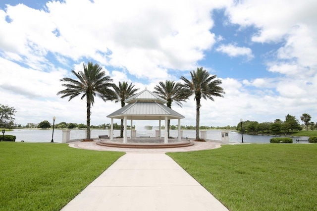 view of community featuring a gazebo, a water view, and a yard