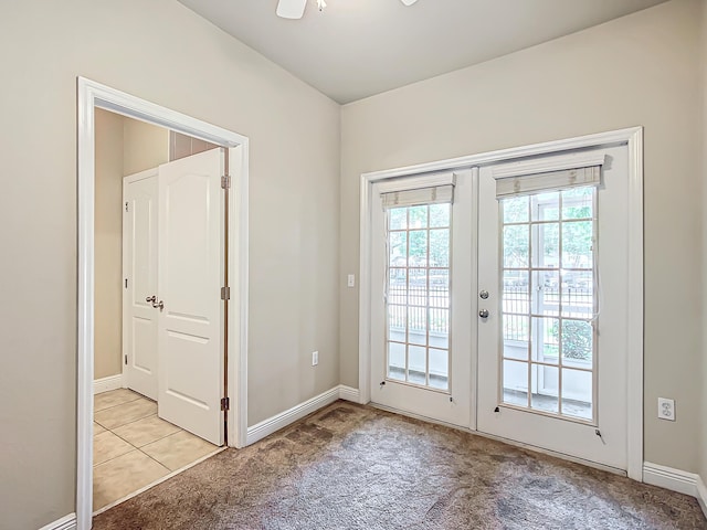 entryway with french doors and light colored carpet