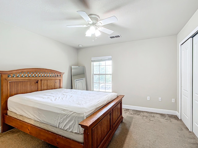 bedroom featuring light carpet and ceiling fan