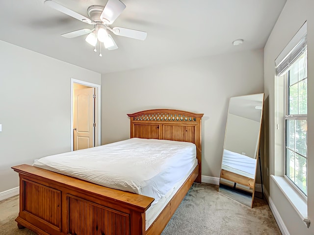 bedroom with light carpet and ceiling fan