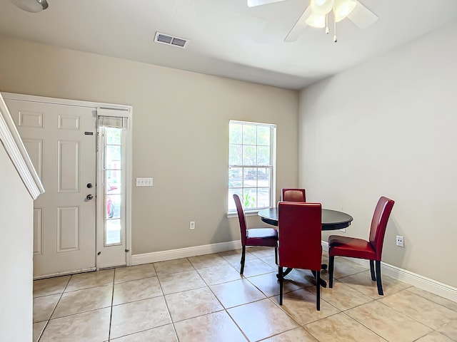 tiled dining space with ceiling fan