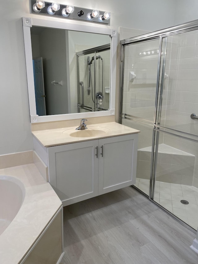 bathroom featuring vanity and a shower with door