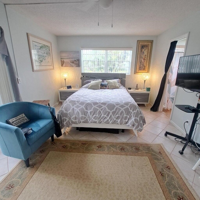 bedroom with light tile patterned floors and a textured ceiling