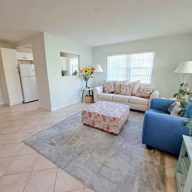 living room featuring a textured ceiling and light tile patterned flooring