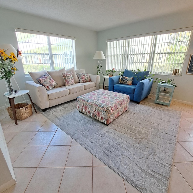 tiled living room featuring a textured ceiling