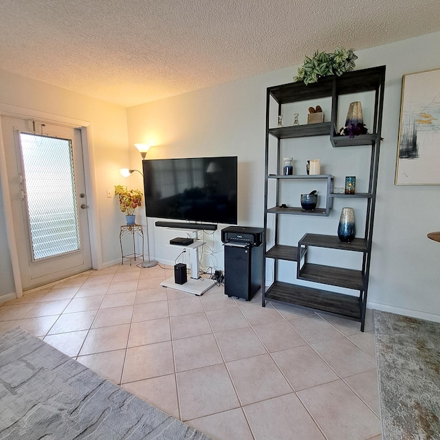 tiled living room featuring a textured ceiling