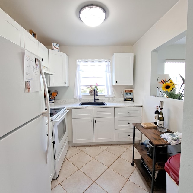 kitchen with white cabinetry, sink, white appliances, and light tile patterned floors