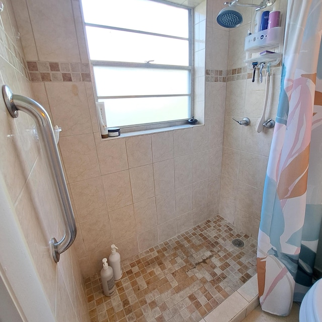 bathroom with toilet and walk in shower