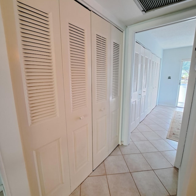 hall with light tile patterned flooring