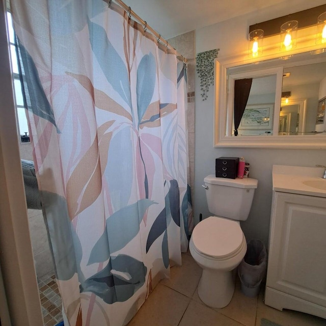 bathroom featuring vanity, a shower with shower curtain, tile patterned floors, and toilet