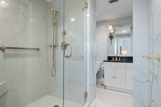 bathroom featuring toilet, a shower stall, visible vents, and vanity