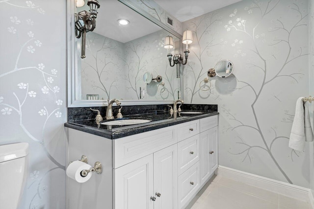 bathroom with double vanity, tile patterned flooring, a sink, and visible vents