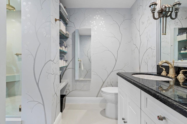 bathroom featuring toilet, vanity, tile patterned flooring, baseboards, and wallpapered walls