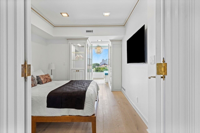 bedroom with visible vents, baseboards, access to outside, light wood-type flooring, and crown molding