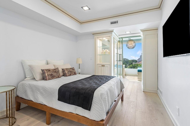 bedroom with crown molding, visible vents, light wood-style floors, access to outside, and baseboards