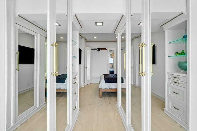 walk in closet featuring light wood-style flooring and french doors