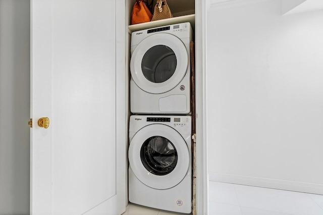 laundry area with stacked washer / drying machine and laundry area