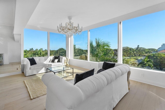 sunroom / solarium featuring a notable chandelier