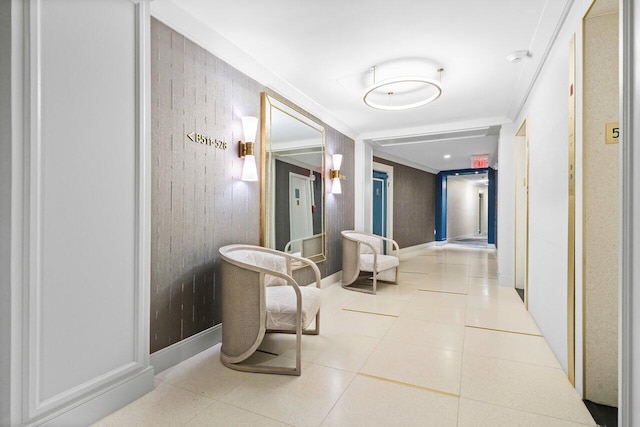 corridor featuring baseboards, ornamental molding, and light tile patterned flooring