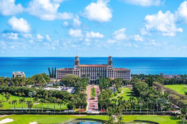 drone / aerial view featuring view of golf course and a water view