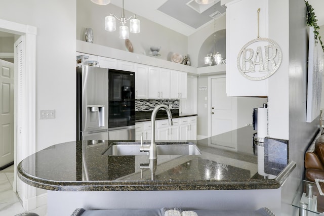 kitchen with stainless steel fridge with ice dispenser, dark stone countertops, white cabinets, a chandelier, and kitchen peninsula