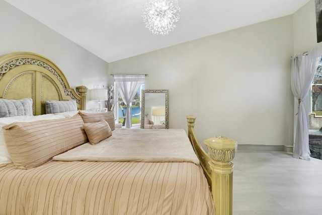 bedroom with vaulted ceiling and a chandelier