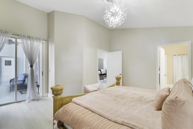 bedroom with high vaulted ceiling, a chandelier, light wood-type flooring, and access to outside