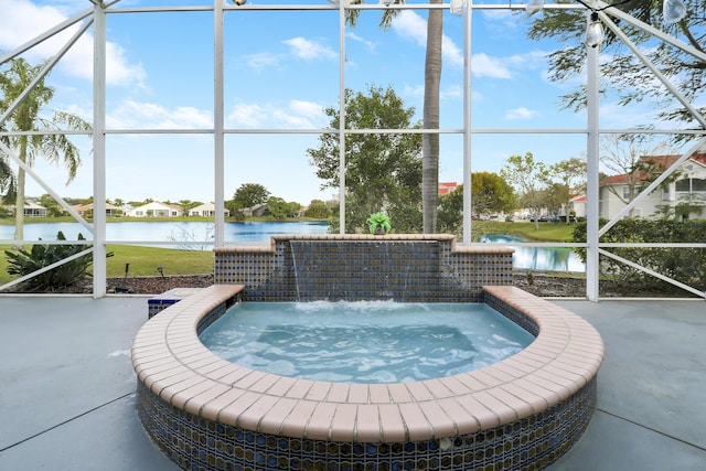 view of swimming pool featuring a water view, pool water feature, a hot tub, and a patio