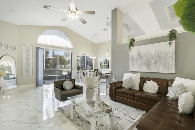 living room featuring ceiling fan with notable chandelier and high vaulted ceiling