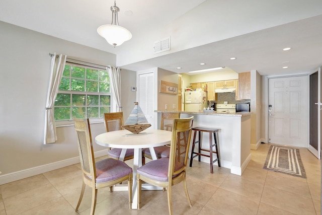 dining area with light tile patterned floors