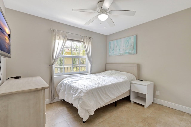 tiled bedroom featuring ceiling fan