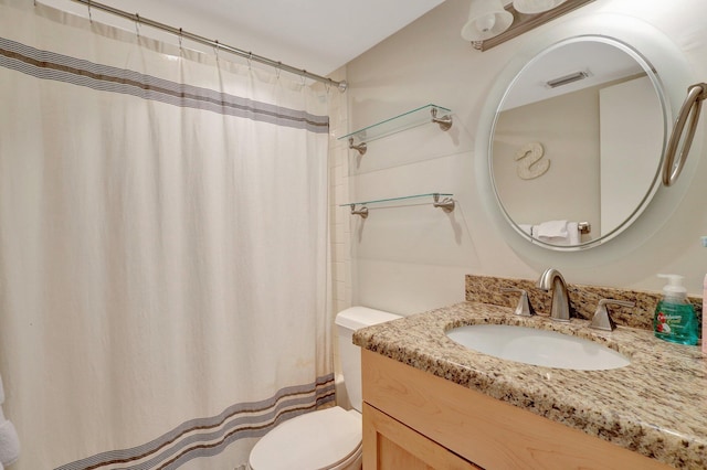 bathroom with vanity, curtained shower, and toilet