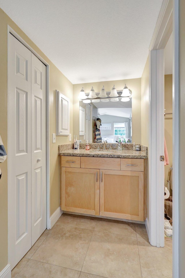 bathroom featuring tile patterned flooring and vanity