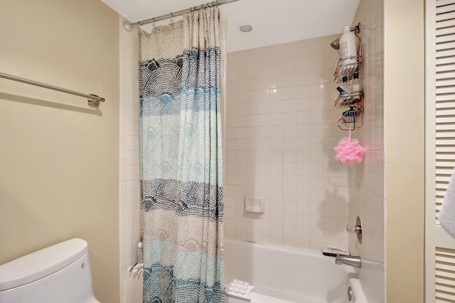 bathroom featuring shower / bath combo and toilet