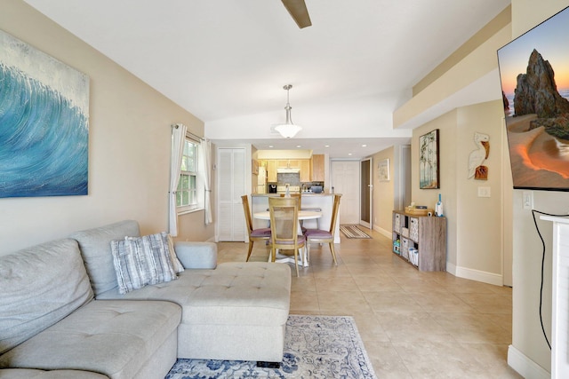 living room with lofted ceiling and light tile patterned floors