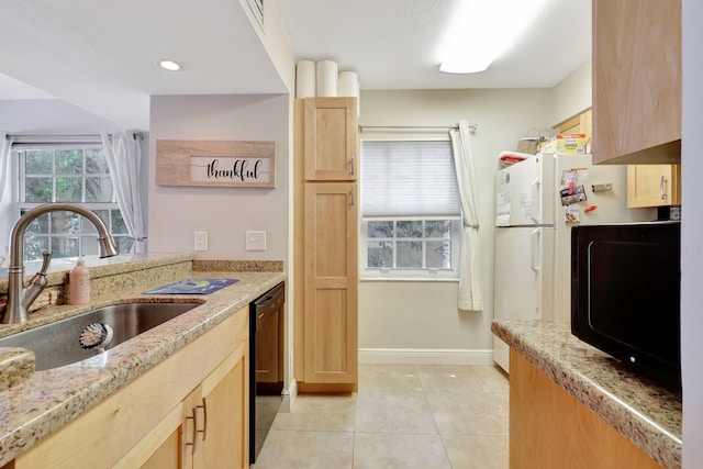 kitchen with light tile patterned flooring, sink, light brown cabinets, light stone countertops, and black appliances