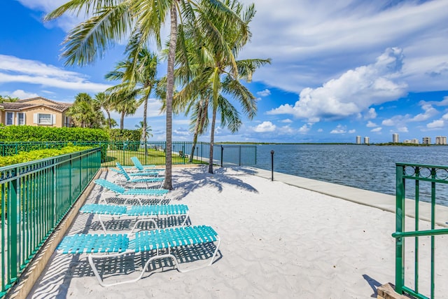 surrounding community featuring a water view and volleyball court