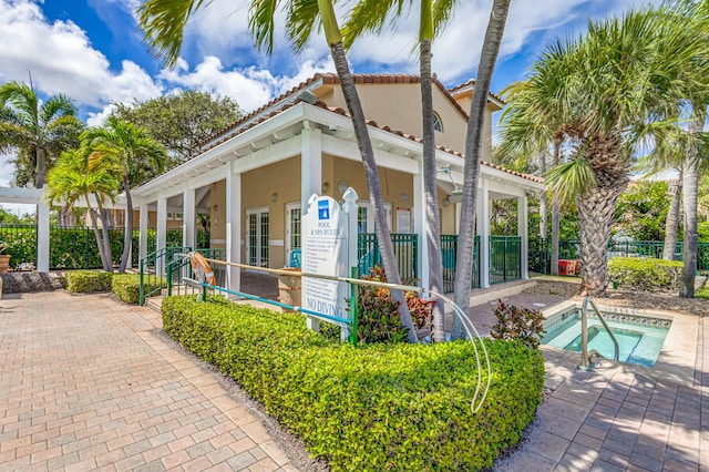 view of side of property with a hot tub