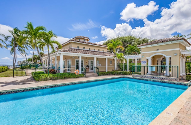 view of swimming pool with french doors, a pergola, and a patio