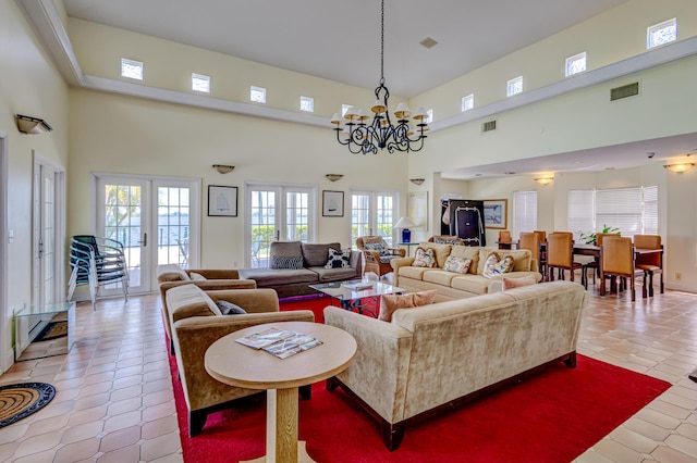 living room with an inviting chandelier, a wealth of natural light, french doors, and a high ceiling