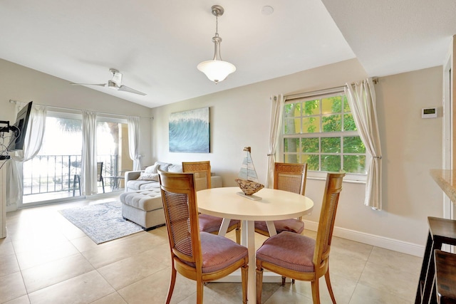 tiled dining room with lofted ceiling, a healthy amount of sunlight, and ceiling fan