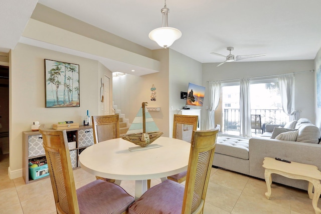 dining space with light tile patterned floors and ceiling fan