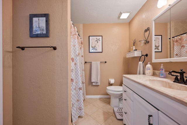 bathroom featuring vanity, tile patterned floors, and toilet